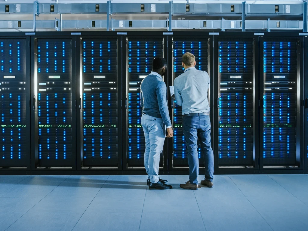 men standing in front of data center server racks