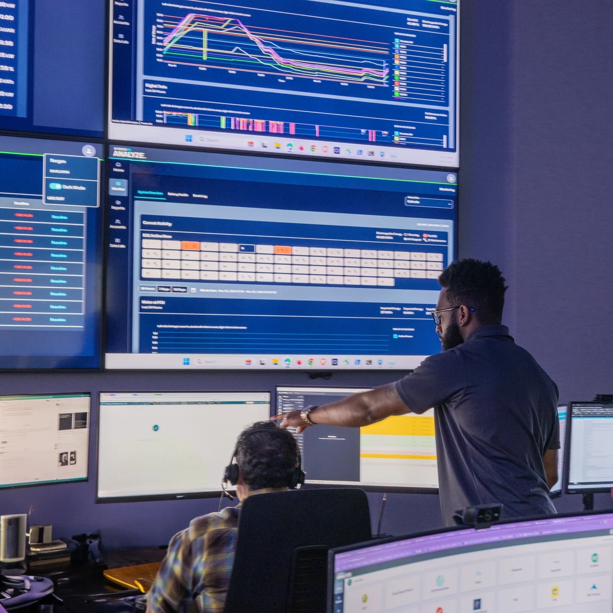 People working in room with data on large screens